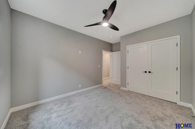 unfurnished bedroom featuring ceiling fan, light carpet, and a closet