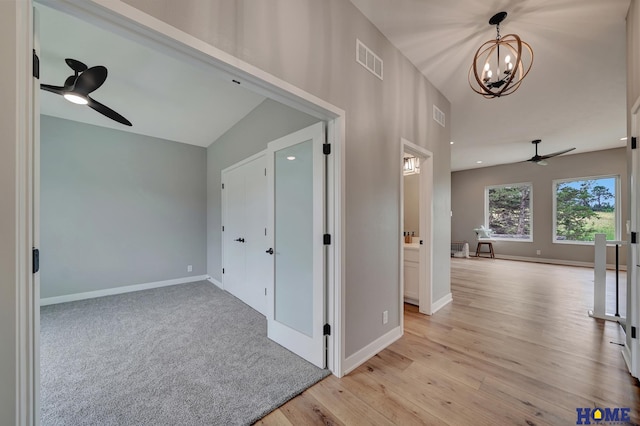 hallway featuring a chandelier and light wood-type flooring