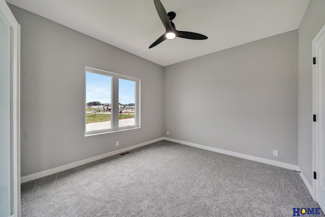 spare room featuring ceiling fan and carpet flooring