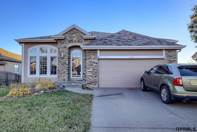 view of front of property with a garage and a front lawn