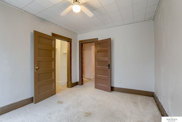 empty room with light colored carpet and ceiling fan