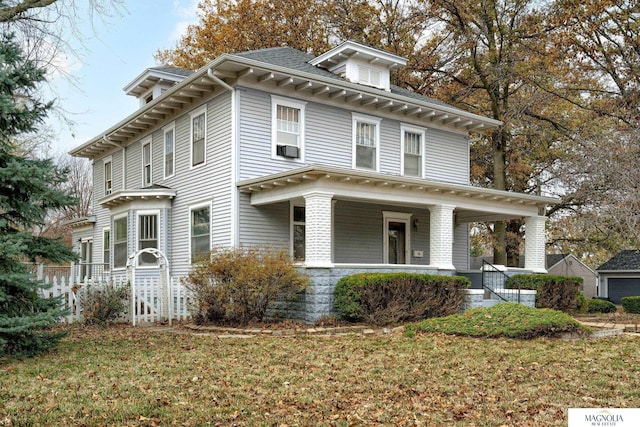 italianate house with a front yard and covered porch