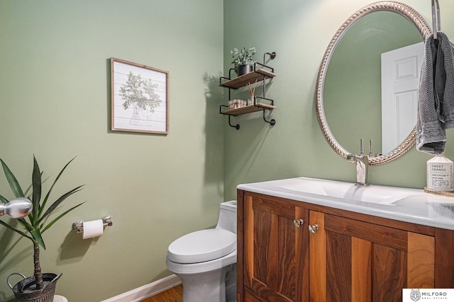 bathroom featuring vanity and toilet