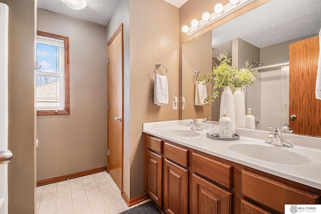 bathroom with vanity and a textured ceiling