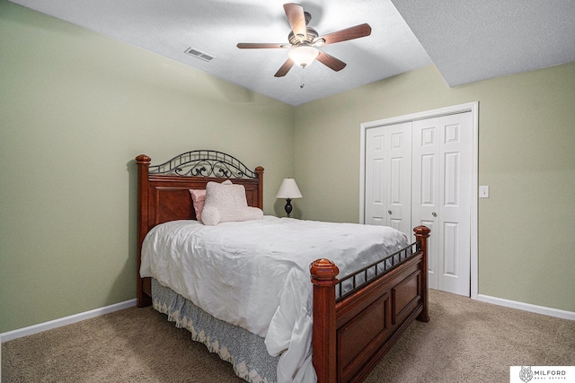 carpeted bedroom featuring ceiling fan and a closet