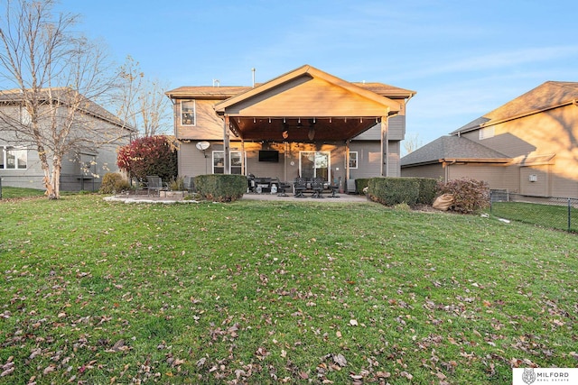 rear view of house with a lawn, ceiling fan, and a patio area