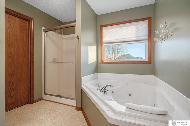 bathroom featuring plus walk in shower and a textured ceiling