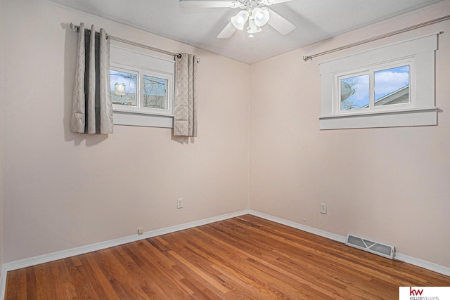 spare room with hardwood / wood-style flooring and ceiling fan