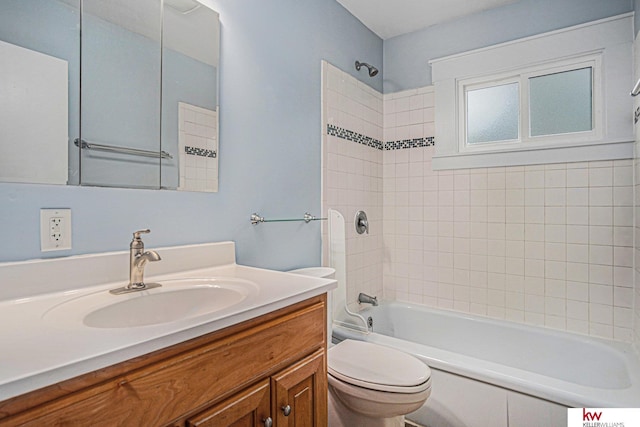 full bathroom with vanity, toilet, and tiled shower / bath combo