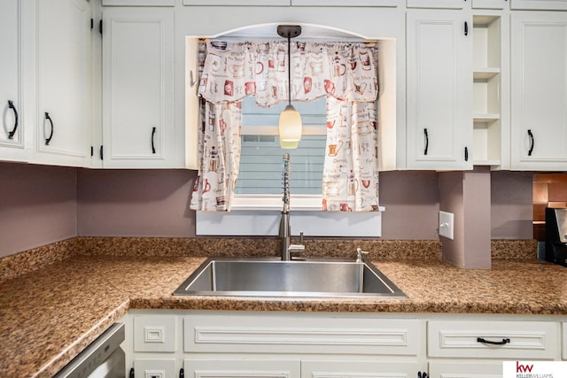 kitchen featuring white cabinetry, decorative light fixtures, dishwasher, and sink