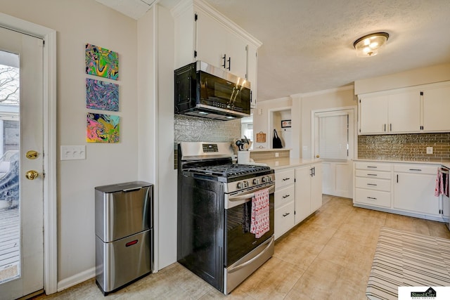 kitchen featuring backsplash, stainless steel appliances, a textured ceiling, and white cabinets