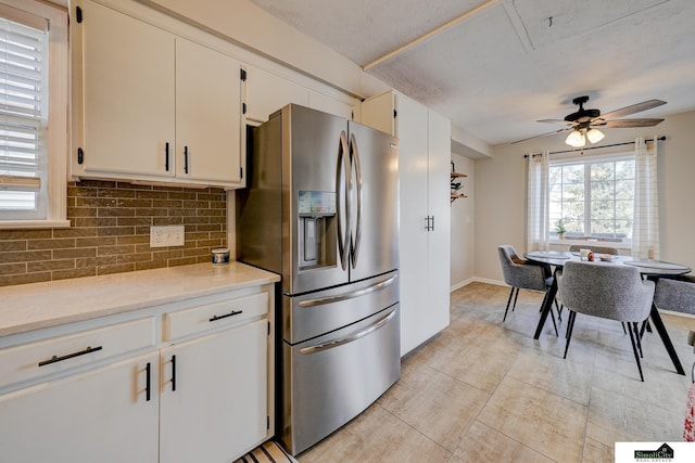 kitchen featuring white cabinetry, stainless steel fridge with ice dispenser, backsplash, and ceiling fan