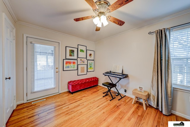 misc room featuring ornamental molding, a wealth of natural light, and light wood-type flooring