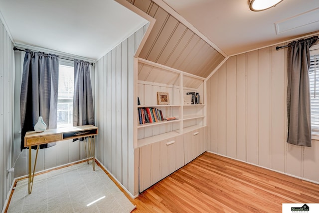 interior space with hardwood / wood-style flooring, lofted ceiling, and built in shelves