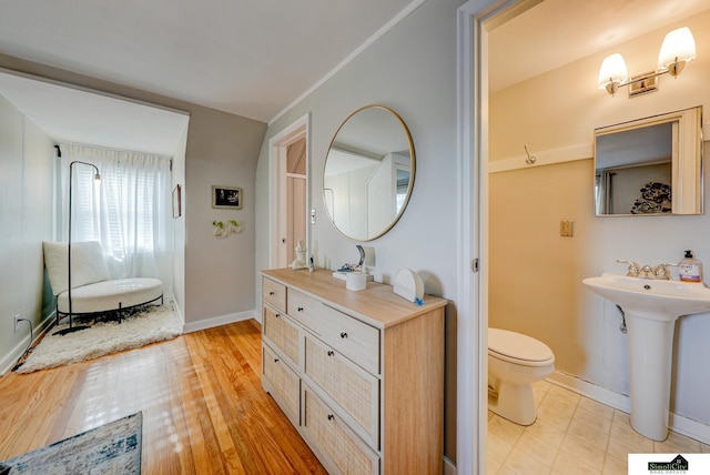 bathroom featuring sink, hardwood / wood-style flooring, and toilet