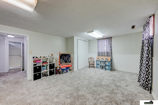 basement with carpet floors and a textured ceiling