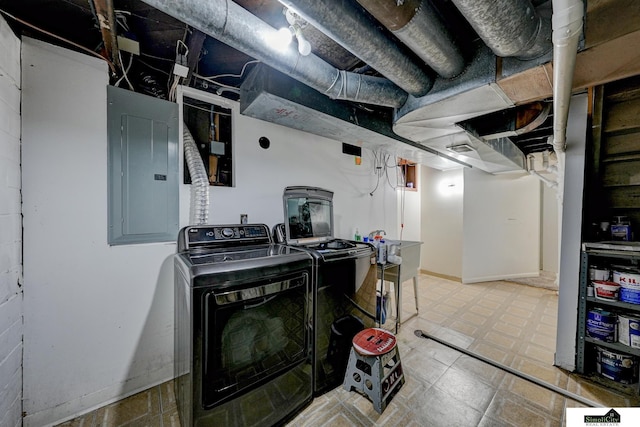 clothes washing area with electric panel and washer and clothes dryer