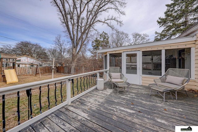 deck featuring a sunroom and a playground