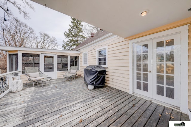 deck featuring french doors, grilling area, and a sunroom