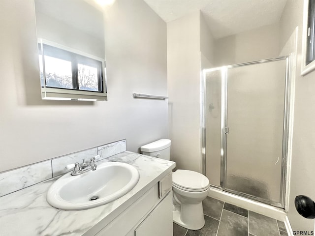 bathroom featuring vanity, an enclosed shower, tile patterned floors, and toilet