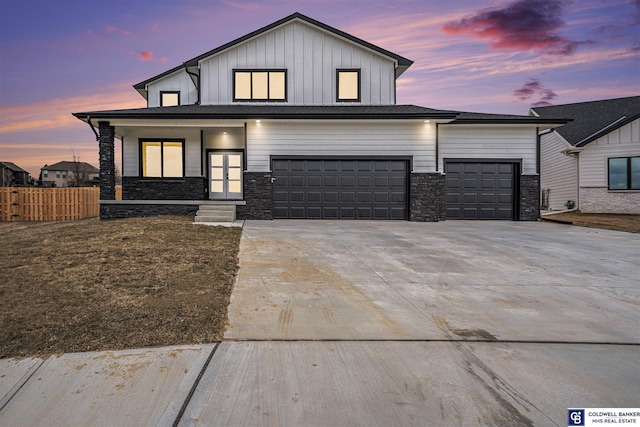 view of front of home with a garage and a lawn