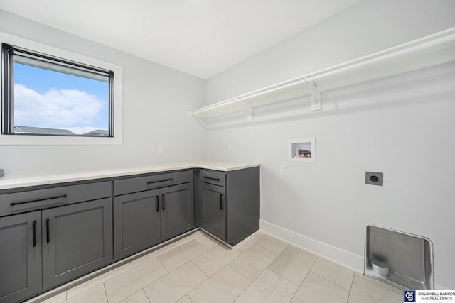 clothes washing area with cabinets, washer hookup, and hookup for an electric dryer