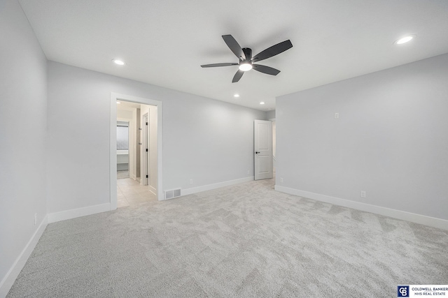 unfurnished room with ceiling fan and light carpet