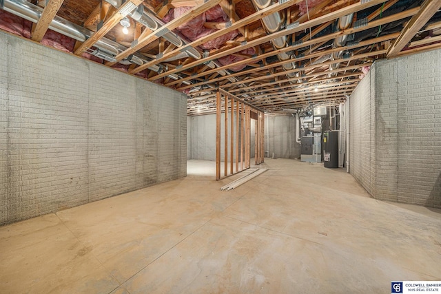 basement featuring brick wall and water heater