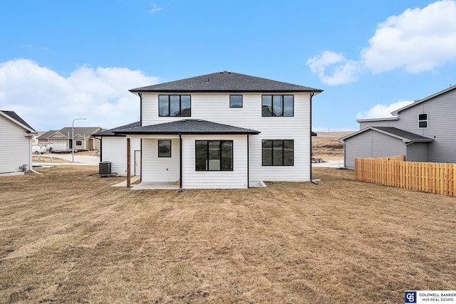 back of property featuring a patio, a yard, and central AC