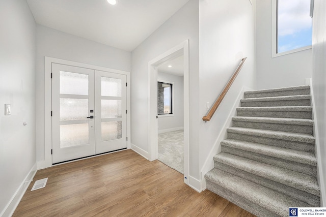 entrance foyer featuring light hardwood / wood-style floors and french doors