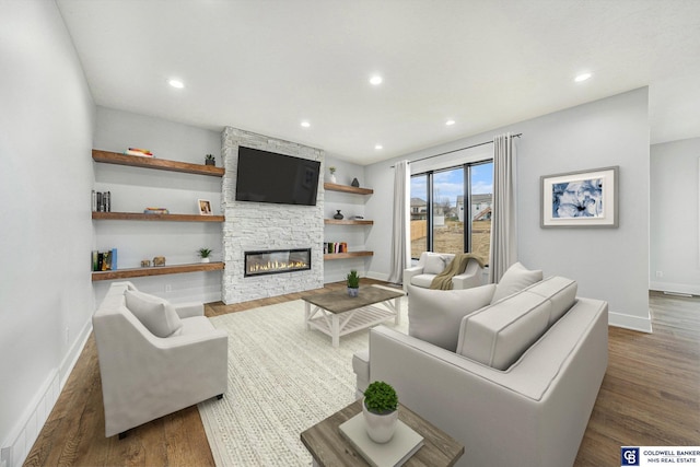 living room with dark hardwood / wood-style flooring and a fireplace