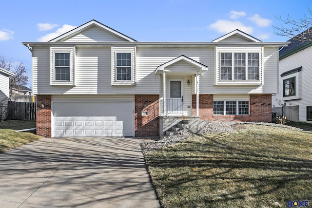 bi-level home with a garage and a front yard