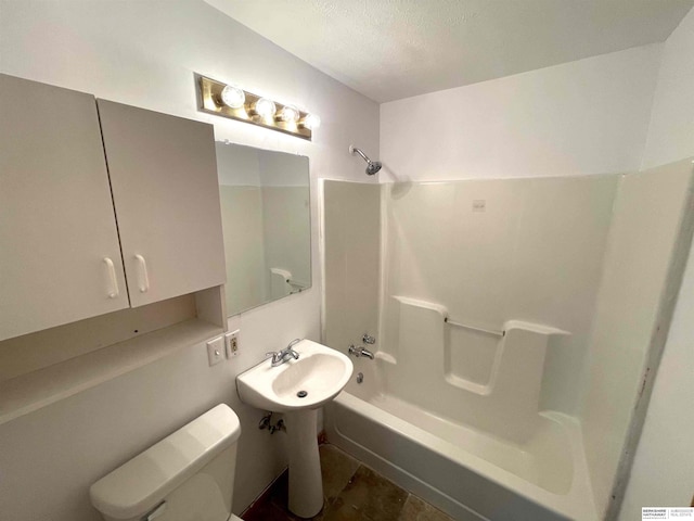 bathroom featuring tub / shower combination, a textured ceiling, and toilet