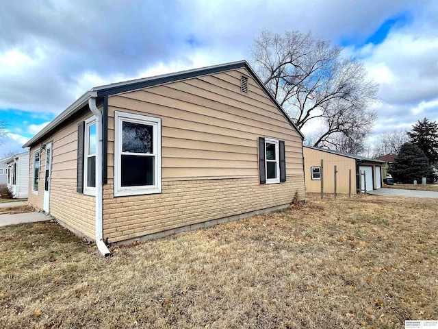 view of home's exterior featuring a garage and a yard