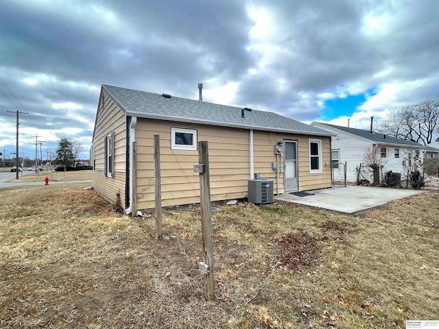 back of house featuring a yard, a patio, and central air condition unit