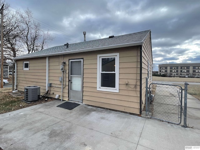 rear view of property featuring central AC and a patio area