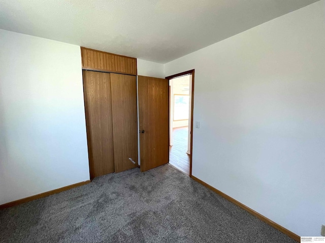 unfurnished bedroom featuring carpet flooring and a closet