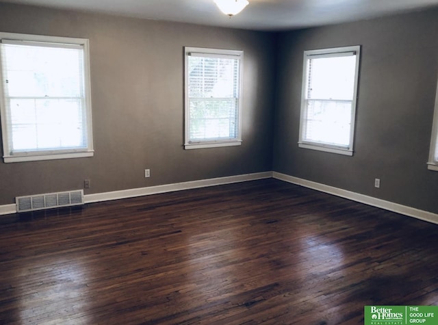 spare room with dark hardwood / wood-style flooring