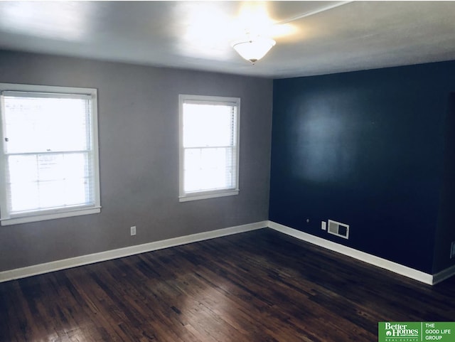 spare room with dark hardwood / wood-style flooring