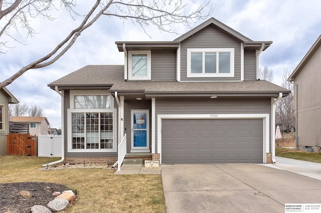 view of front of house featuring a garage and a front yard