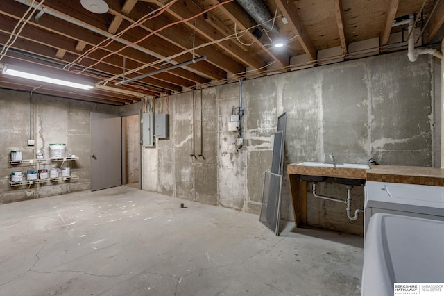 basement featuring electric panel and sink