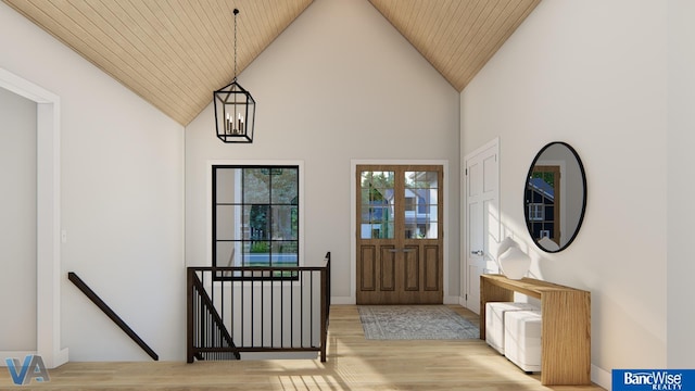 foyer featuring wood ceiling, a towering ceiling, an inviting chandelier, and light wood-type flooring