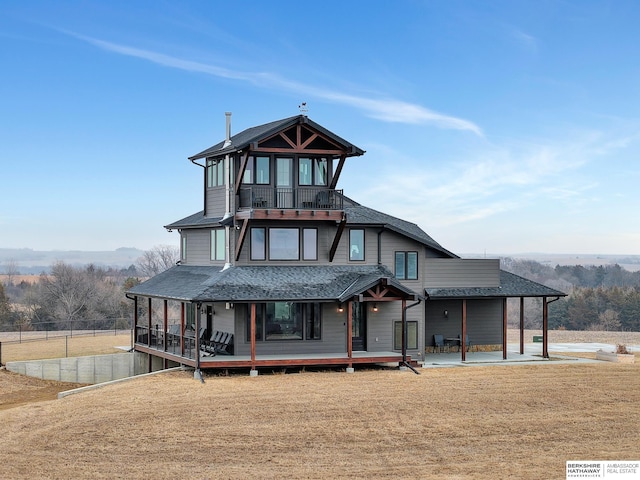 view of front facade featuring a sunroom, a patio area, and a front yard