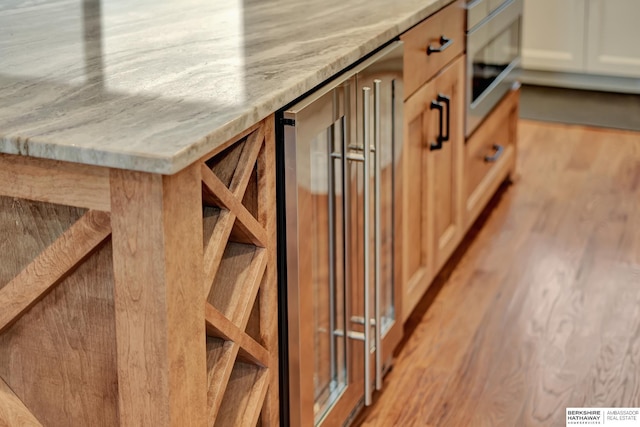 interior details with light stone countertops and beverage cooler