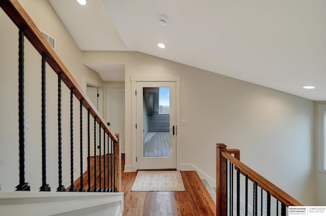 foyer entrance featuring vaulted ceiling and light hardwood / wood-style flooring