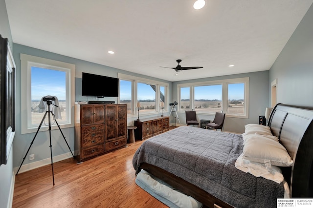 bedroom with ceiling fan and light wood-type flooring