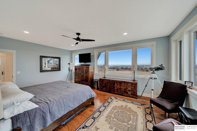 bedroom with ceiling fan and light wood-type flooring