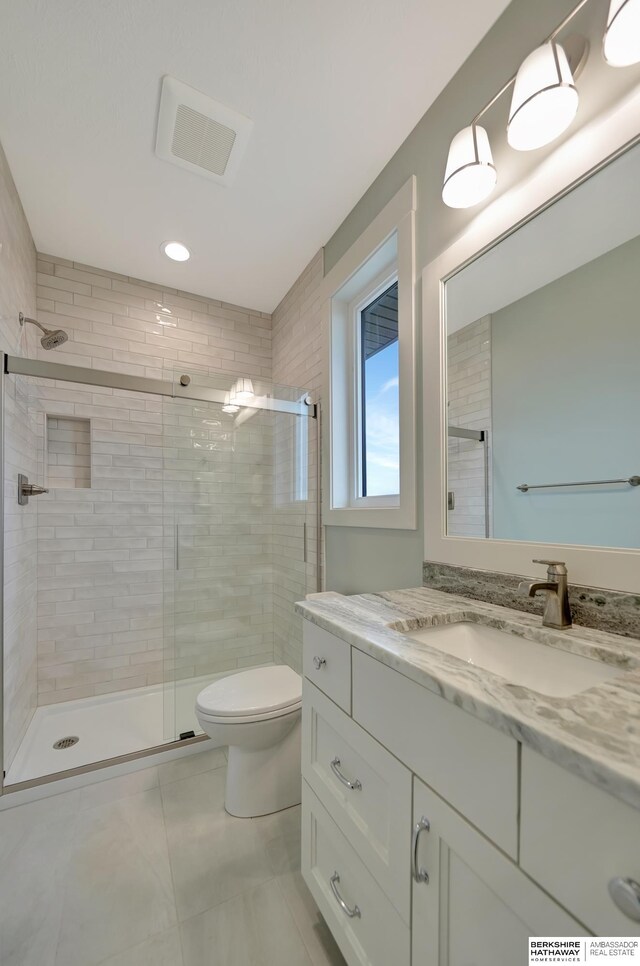 bathroom with vanity, toilet, and walk in shower