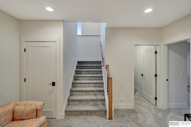 stairway featuring carpet