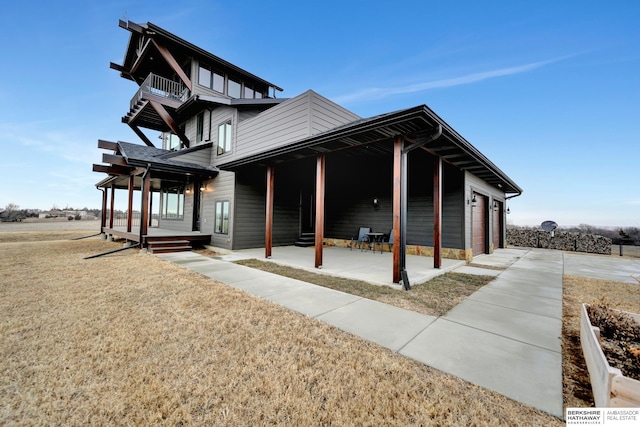 view of home's exterior with a garage and a lawn